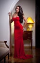 Sensual elegant young woman in red dress and indoor shot Royalty Free Stock Photo