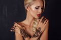 Sensual girl with blond hair with mehendi pattern on hands Royalty Free Stock Photo