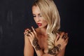 Sensual girl with blond hair with mehendi pattern on hands