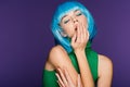 Sensual girl in blue wig posing with closed eyes, isolated