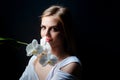 Sensual girl with orchid flower. Woman and orchids on black. Portrait of cute female face. Royalty Free Stock Photo