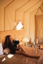 Sensual glamour portrait woman in interior of modern luxury glamping tent camp Royalty Free Stock Photo