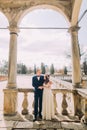 Sensual husband and wife hugging under archway in antique ruined palace Royalty Free Stock Photo