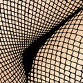 Legs of woman in fishnet stockings Royalty Free Stock Photo