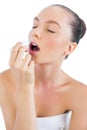 Sensual model putting lip balm on Royalty Free Stock Photo
