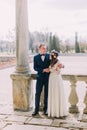 Sensual newlywed husband and wife hugging under archway in antique ruined palace Royalty Free Stock Photo