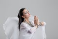 Sensual oriental belly dancer performance pray on grey