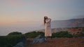 Sensual performer dancing ocean landscape at summer evening. Woman on cliff Royalty Free Stock Photo