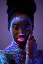 sensual photo of young stunning black woman with flurescent make-up on body