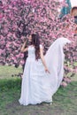 Sensual portrait of a spring woman, beautiful face, close up on blue eyes, female enjoying cherry blossom Royalty Free Stock Photo