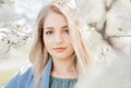 Sensual portrait of a spring woman, beautiful face, female enjoying cherry blossom, tree branch and natural beauty Royalty Free Stock Photo