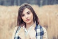 Sensual portrait of a woman, beautiful face female enjoying nature, thinking dreamy girl in beige coat and blue white scarf Royalty Free Stock Photo