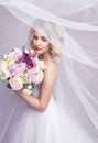 Sensual portrat of young beautiful bride holding flower bouquet