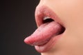 Sensual seductive mouth closeup. Woman shows sexy tongue.