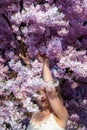 Sensual seductive young sexy blonde woman portrait surrounded by japanese cherry blossoms