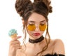 Sensual brunette woman in round glasses with ice cream in hand