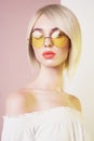 Sensual stylish woman in erotic white dress. Blue-eyed lady with perfect lips in modern colour sunglasses Royalty Free Stock Photo