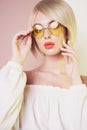 Sensual stylish woman in erotic white dress. Blue-eyed lady with perfect lips in modern colour sunglasses Royalty Free Stock Photo