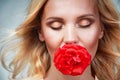 Sensual tender young woman portrait with breeze hair and rose in Royalty Free Stock Photo