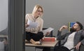 Sensual woman and bearded man work together in office. Businesswoman and businessman write business plan. Concentrated