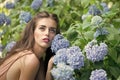 Sensual woman body. Portrait of beautiful woman and blue flowers Royalty Free Stock Photo