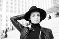 Sensual woman with brunette hair, hairstyle. Woman in black hat pose on stairs in paris, france, fashion. Beauty, look Royalty Free Stock Photo