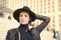 Sensual woman with brunette hair, hairstyle. Woman in black hat pose on stairs in paris, france, fashion. Beauty, look Royalty Free Stock Photo