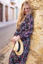 Sensual woman in floral pattern dress posing in city