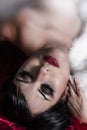 Sensual woman lying in red bed, silk Royalty Free Stock Photo