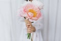 Sensual woman with peony bouquet in hands. Stylish female holding peonies flowers. Bridal morning Royalty Free Stock Photo