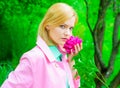 Sensual woman in pink coat with peony flower in park. Romantic girl with peonies in garden. Spring. Royalty Free Stock Photo