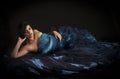 Sensual woman reclining in blue evening dress Royalty Free Stock Photo