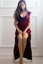 Sensual woman in red dress sitting on chair Royalty Free Stock Photo