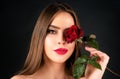 Sensual woman with red lips with red rose, isolated background. Beautiful young pretty woman with healthy skin and red Royalty Free Stock Photo