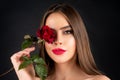 Sensual woman with red lips with red rose, isolated background. Beautiful young pretty woman with healthy skin and red Royalty Free Stock Photo