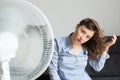 Sensual woman refreshing in front of cooling fan