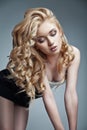 Sensual woman with shiny curly long blond hair