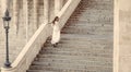 Sensual woman on staircase. Woman bride in white wedding dress, fashion. Girl with glamour look. Fashion model with long Royalty Free Stock Photo