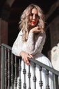 Sensual woman on staircase. Woman bride in white wedding dress. Girl with glamour look. Fashion model. Royalty Free Stock Photo
