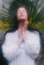 Sensual woman standing with arms folded and eyes closed. Soft focus