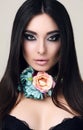 Sensual woman with straight black hair with bright makeup and flower's necklace Royalty Free Stock Photo