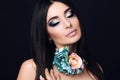 Sensual woman with straight black hair with bright makeup and flower's necklace Royalty Free Stock Photo
