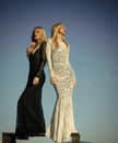 Sensual woman. Two girls with long blond hair posing on blue sky Royalty Free Stock Photo