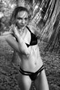 Sensual woman wearing black swimwear on a beautiful summer day between palm trees Royalty Free Stock Photo