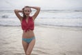 Sensual woman wearing shirt and bikini bottom on a beautiful summer day at the beach. Royalty Free Stock Photo