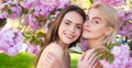 Sensual woman spring outdoor portrait banner. Smiling face of sensual girls. Beautiful young girls on blooming pink Royalty Free Stock Photo
