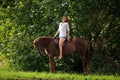 Sensual young beauty cowgirl riding a horse
