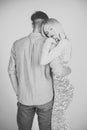 Sensual young couple making love in bedroom. Couple in love hugging on grey background