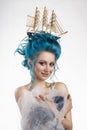 Sensual young girl with naked shoulders and painted blue hair st