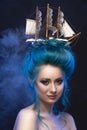 Sensual young girl with naked shoulders and painted blue hair st